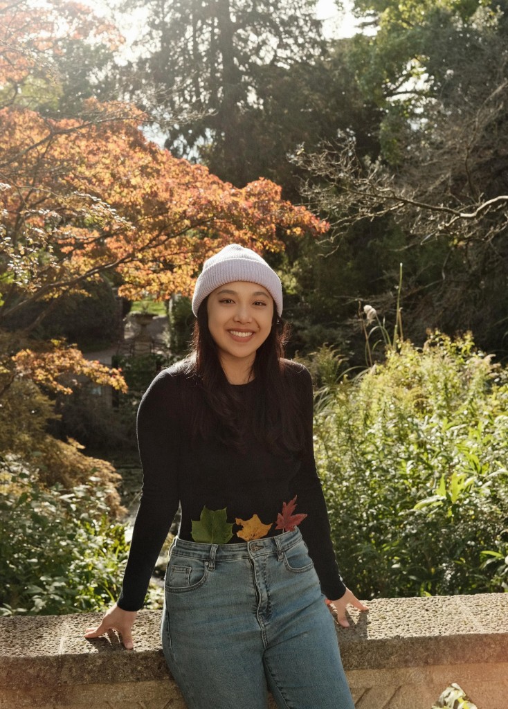Sylvan Shen standing in an autumn garden